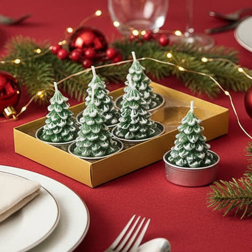 Christmas-themed table setting with decorative trees, ornaments, and lights.