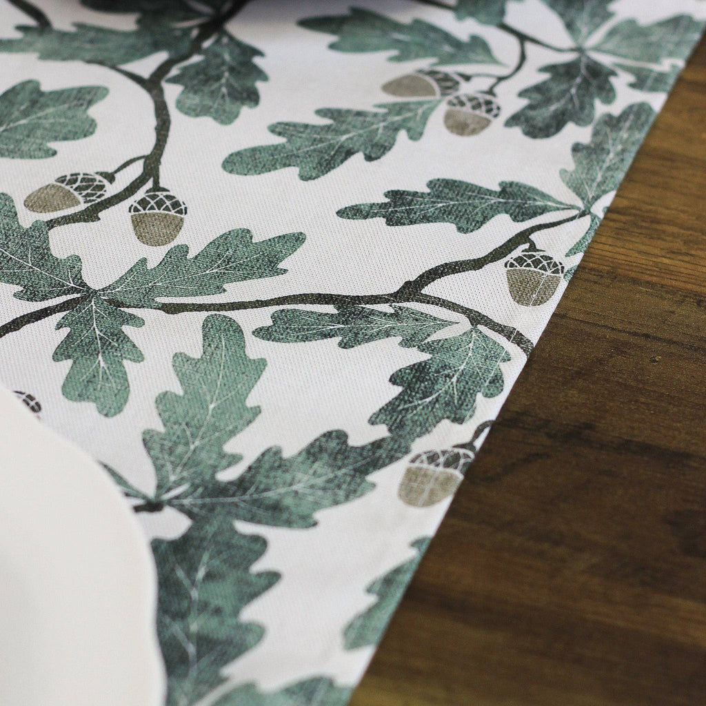 Fabric with green leaf pattern on a wooden surface