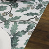 Fabric with green leaf pattern on a wooden surface