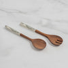 Two wooden serving utensils, a spoon and a salad spinner, with white handles featuring a black textured pattern, displayed on a light gray background.