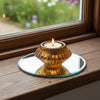 Decorative candle holder with a candle inside on a white background
