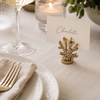 Table setting with gold place card holder, candle,