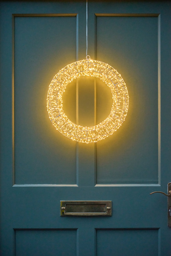 Decorative wreath with lights on a blue door