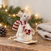 Alpine White Skiing Mouse Christmas Decoration with a striped red scarf and wooden skis in a rustic Nordic setting