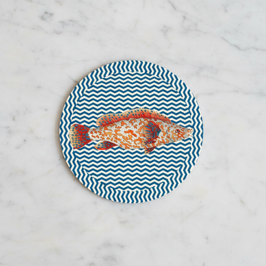 Round plate with a fish design on a blue and white chevron pattern