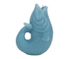Blue fish shaped sculptural candle on white background