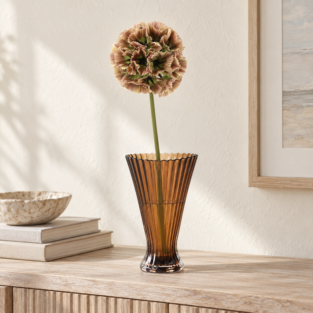 Elowen faux scabious stem styled in an amber glass vase