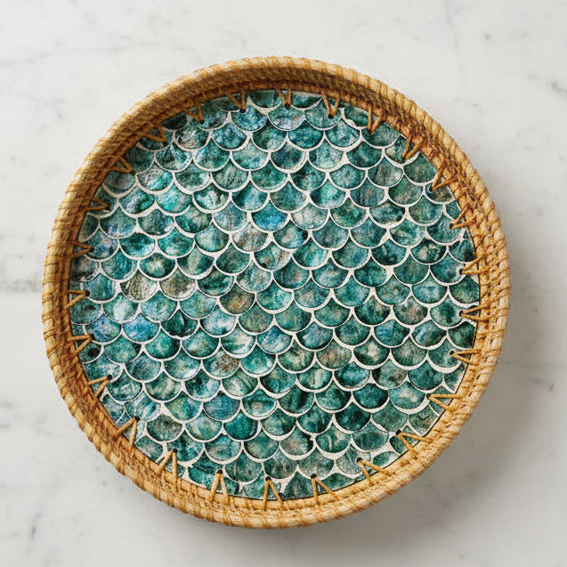 Round woven tray with fish scale pattern on a textured surface