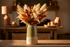 Lifestyle shot of olive green ceramic jug vase styled with dried autumnal stems
