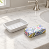 Luberon Provence floral wrapped soap and white ceramic dish beside a basin on a marble vanity