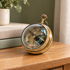 Meridian brass magnifying table clock on an oak bedside chest