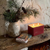 Nordhaven Christmas candle tin styled on a rustic mantel