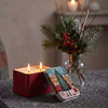 Nordhaven red Christmas candle tin lit beside its illustrated Nordic tree and village lid
