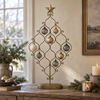 Ottilie antique brass bauble display tree styled in a warm Christmas interior