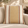 Ravello striped cushion in golden beige cream rust and pale blue on a linen sofa