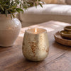 Close view of the lit Solenne gold gingerbread candle