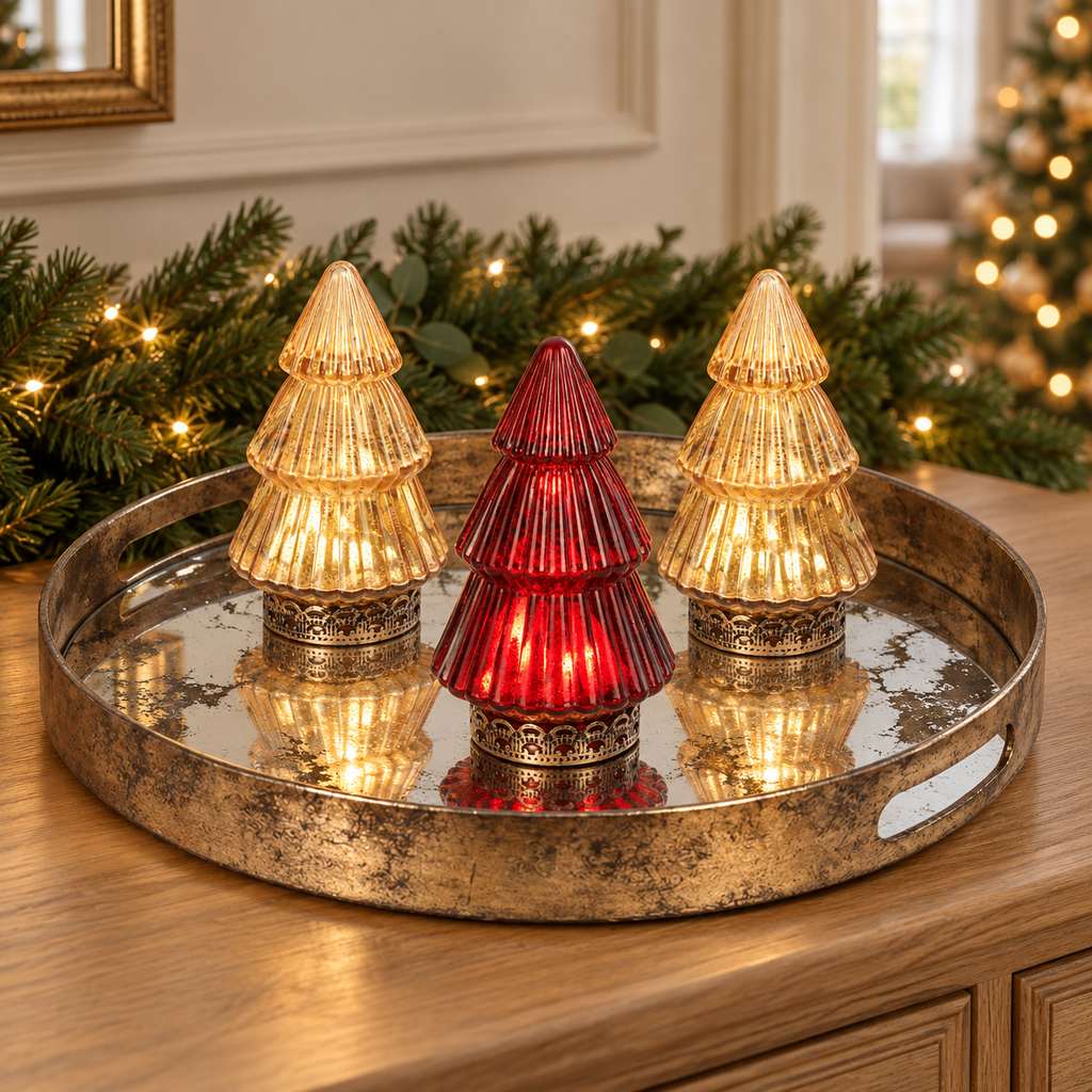 Two gold and one red Vesper glass LED Christmas trees on the Marble Effect Mirror Tray with festive greenery